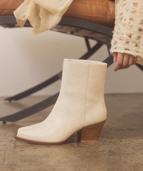 Leather ankle boots with square toe, stacked wooden block heel, side zipper closure, and slip-on style