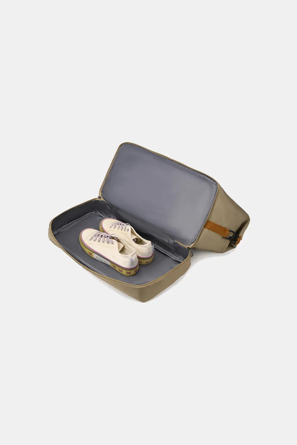 Olive green travel bag with brown accents, shown open with a pair of beige sneakers neatly stored inside. Features a structured design and smooth dark gray interior—ideal for organized shoe storage during travel.
