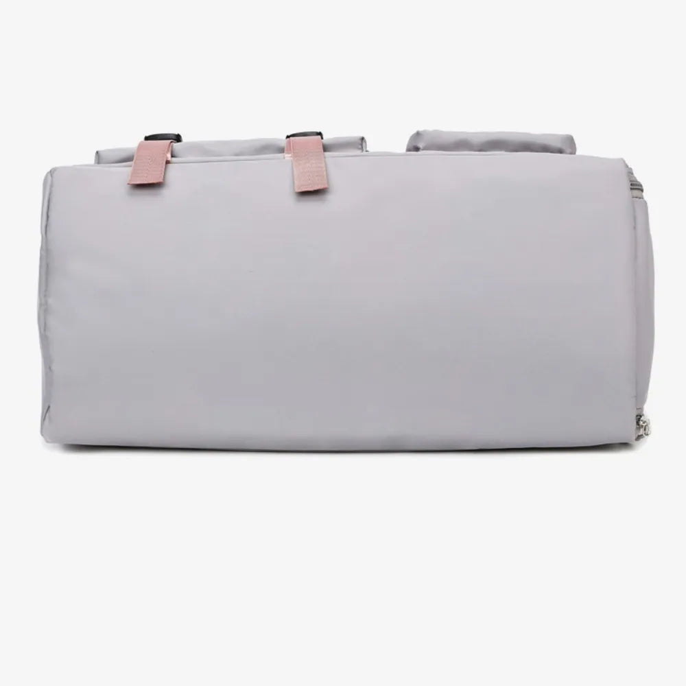 Light gray duffel bag with pink handles and shoulder strap, featuring a front zip pocket and smooth, slightly glossy material. Modern and functional—ideal for gym, travel, or everyday use.
