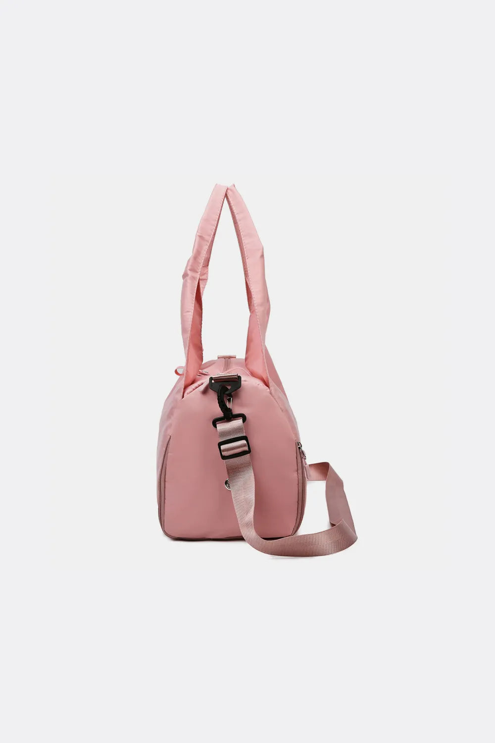 Pink handbag with a soft texture and unique triangular handle, featuring a detachable shoulder strap. Stylish and spacious—great for casual or everyday use.
