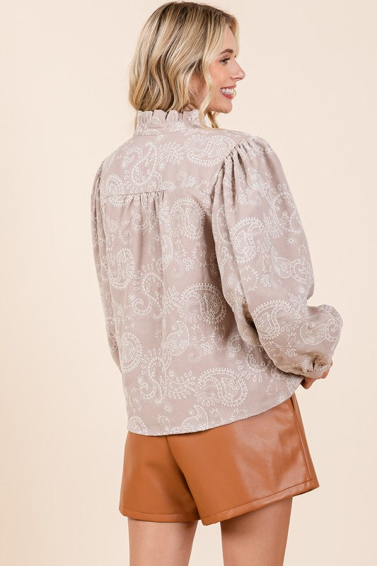 A lined button-up blouse combining paisley motifs and delicate eyelet lace for textured appeal.