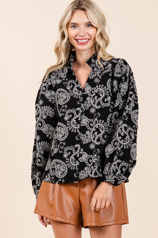 Elegant embroidery meets feminine structure in this eyelet lace button-up top.