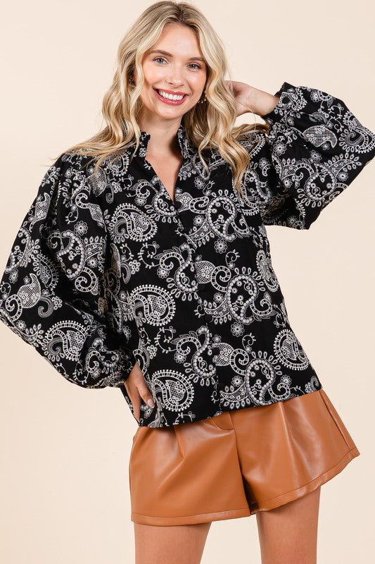 This blouse’s long sleeves, lace detail, and lined body create a polished, elegant look.