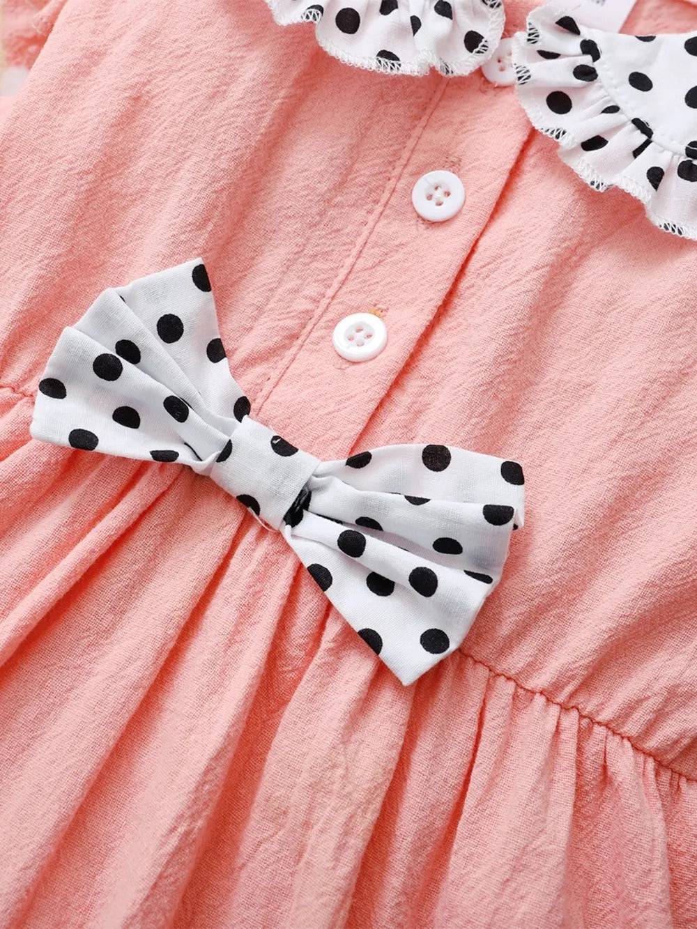 Baby girl pink dress with flutter sleeves, soft knit fabric, and delicate detailing — charming outfit for special occasions
