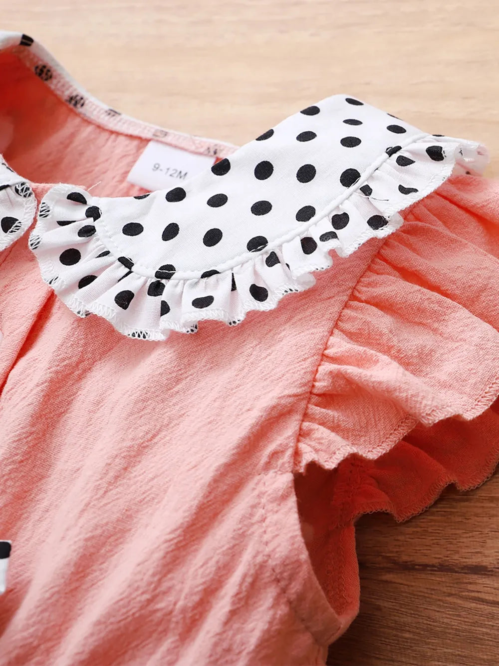Baby girl pink dress with flutter sleeves, soft knit fabric, and delicate detailing — charming outfit for special occasions