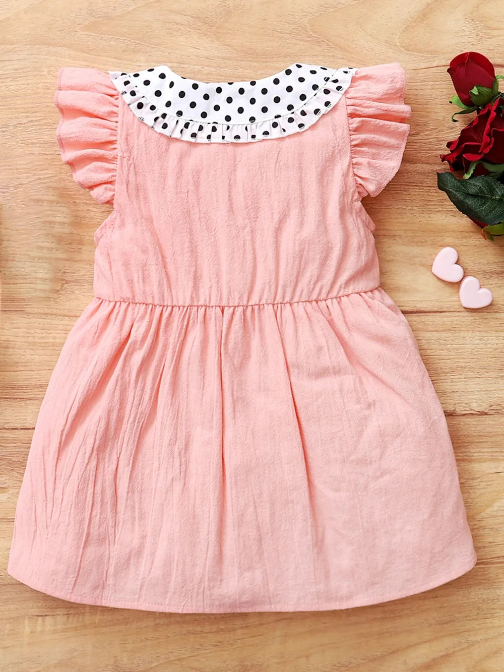 Baby girl pink dress with flutter sleeves, soft knit fabric, and delicate detailing — charming outfit for special occasions
