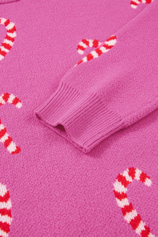 Pink candy cane patterned sweater displayed