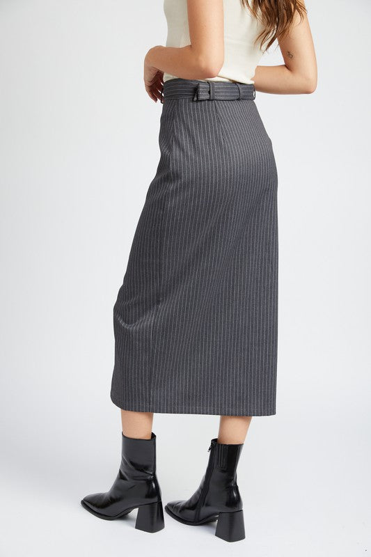 Person wearing a gray pinstripe skirt with black boots on a white background