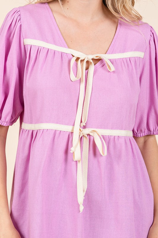 Relaxed fit meets structured detail with piped seams at the neckline and hem.