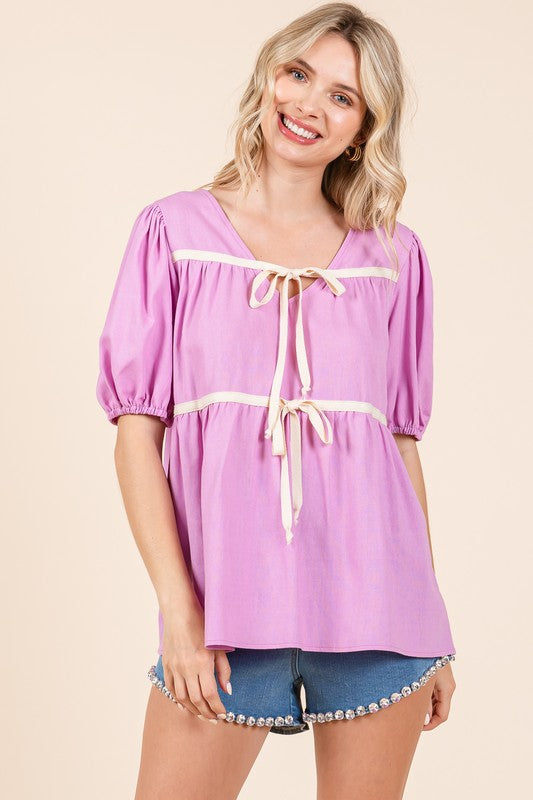 Soft fabric hugs gently at the bust then flows out, framed by subtle piping.