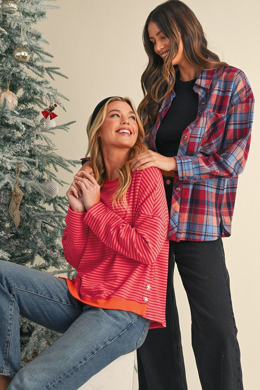 Loose shirt style great for layering over cami or under jackets.