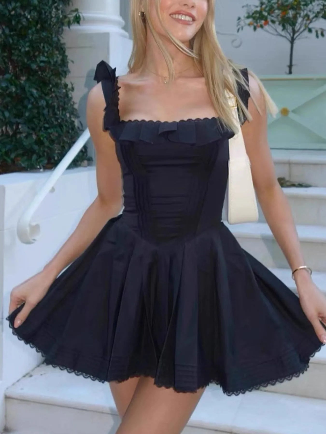 Square neck pleated mini dress with sleeveless design and structured pleats — stylish and flattering for day or evening wear