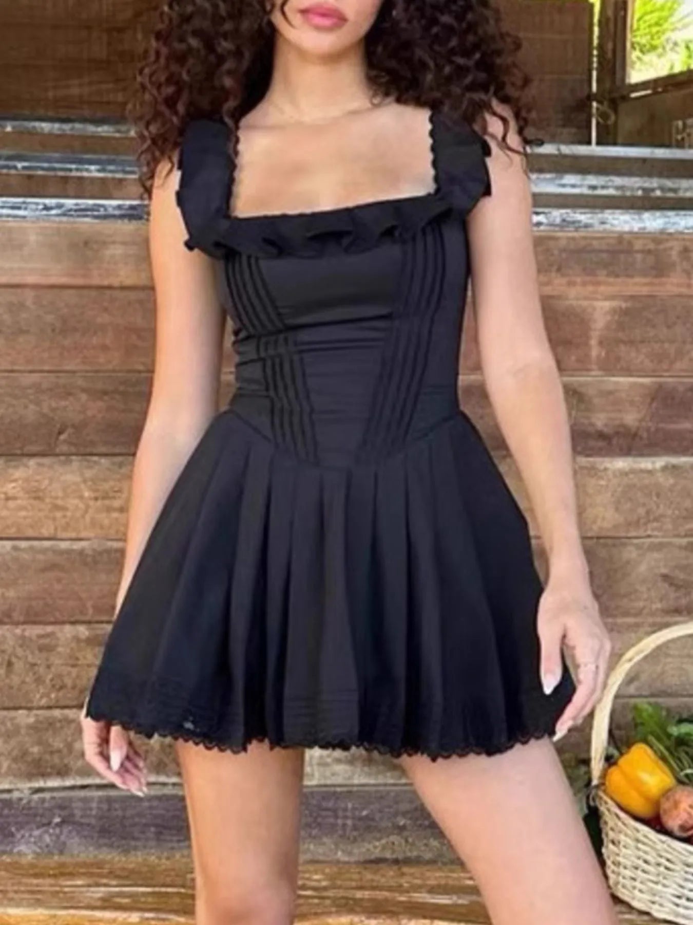 Square neck pleated mini dress with sleeveless design and structured pleats — stylish and flattering for day or evening wear