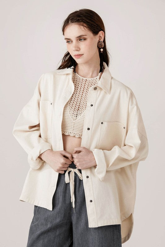 Snap button closure makes layering easy and functional.
