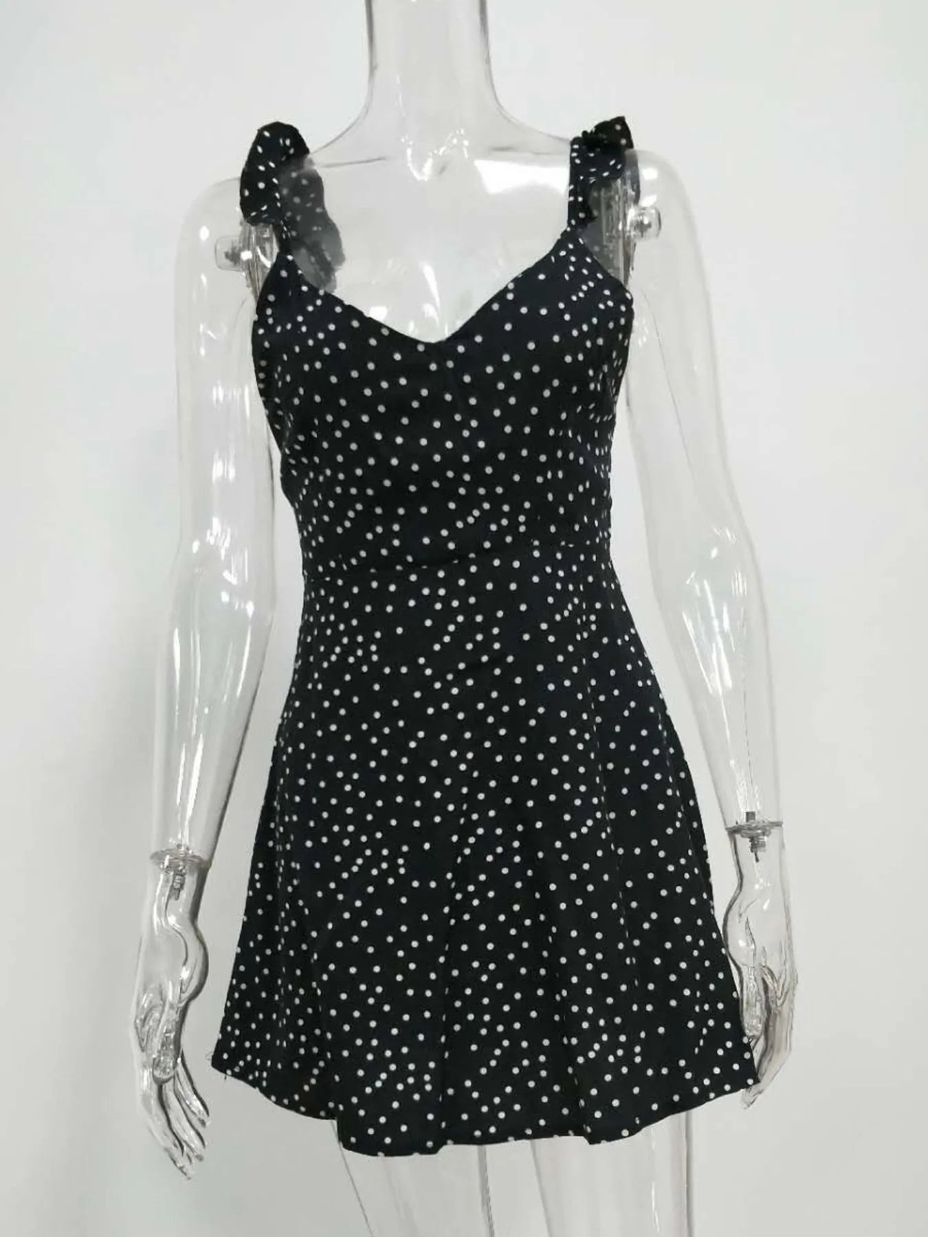 Plus size polka dot mini dress with round neckline, tie-back detail and flattering silhouette — stylish and comfortable for day or evening wear