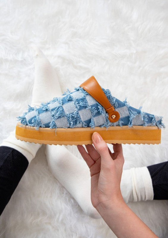 Denim patchwork slip-on shoes with frayed edges, rounded toe, platform sole with lug tread, and pull-tab at heel counter