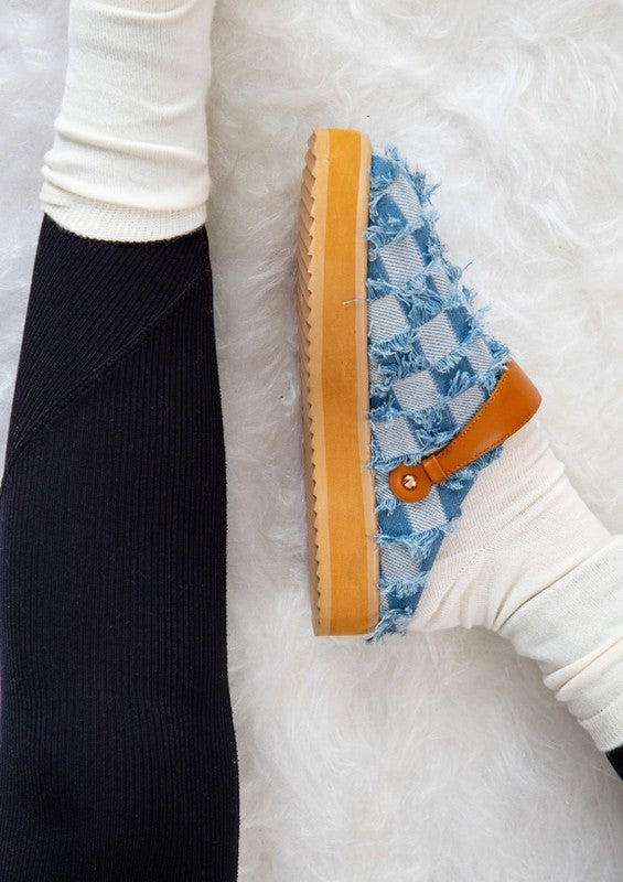 Denim patchwork slip-on shoes with frayed edges, rounded toe, platform sole with lug tread, and pull-tab at heel counter