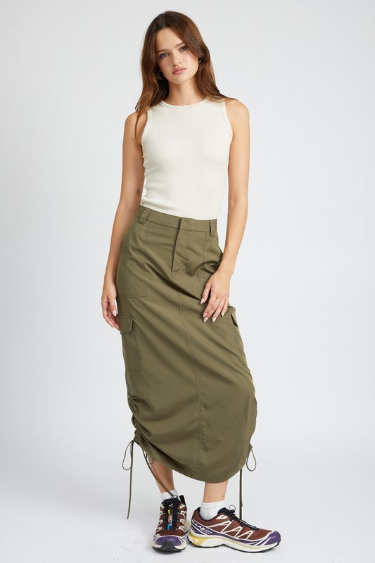 Woman wearing a white sleeveless top and green skirt