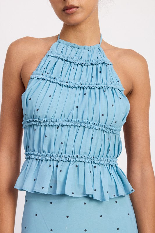 Ruffle trim along the neck and bodice brings feminine movement and detail.