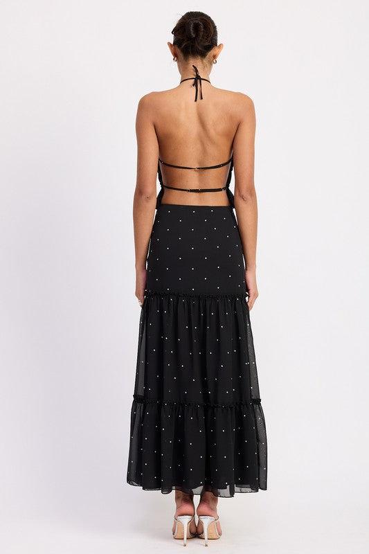 Backless style is balanced by ruffle detail for modesty and visual interest.