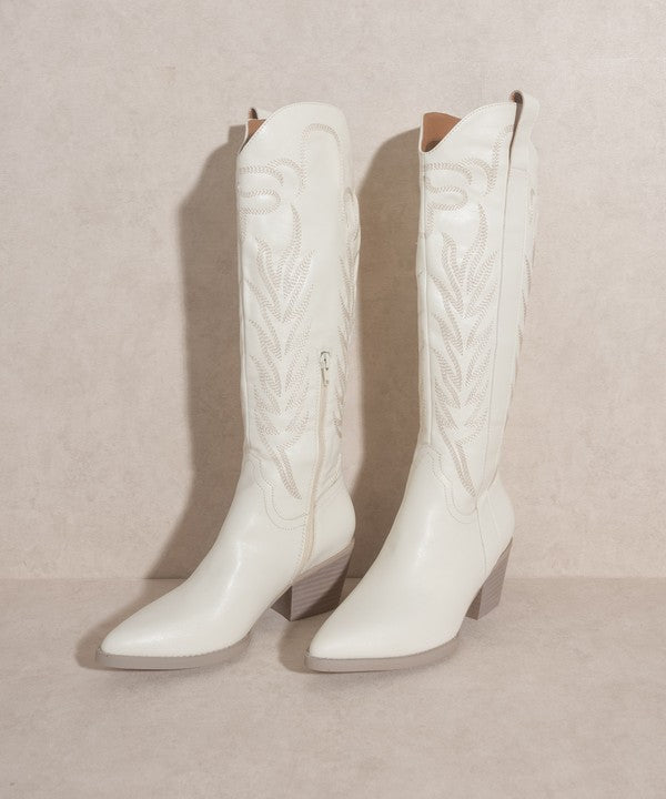 Knee-high western boots with embroidered stitching, pointed toe, stacked block heel, and side zipper closure.