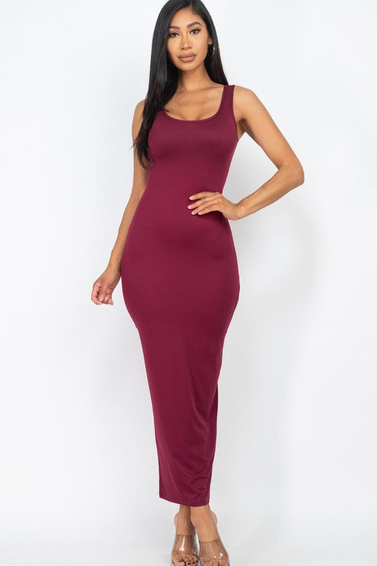 Woman wearing a burgundy sleeveless dress on a white background