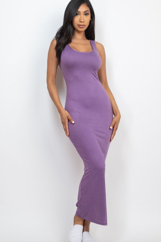 Woman wearing a purple sleeveless dress against a white background