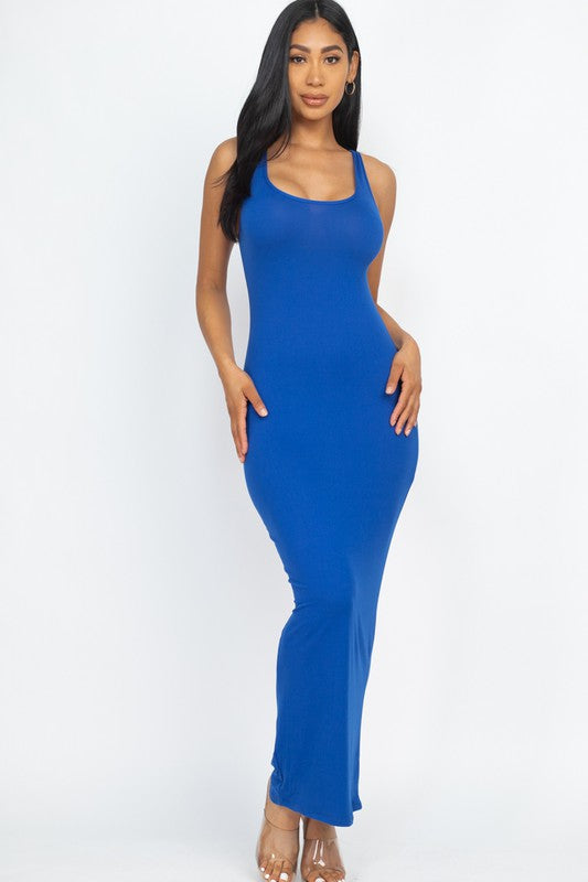 Woman wearing a blue sleeveless dress on a white background