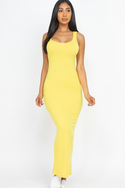Woman wearing a yellow sleeveless dress on a white background