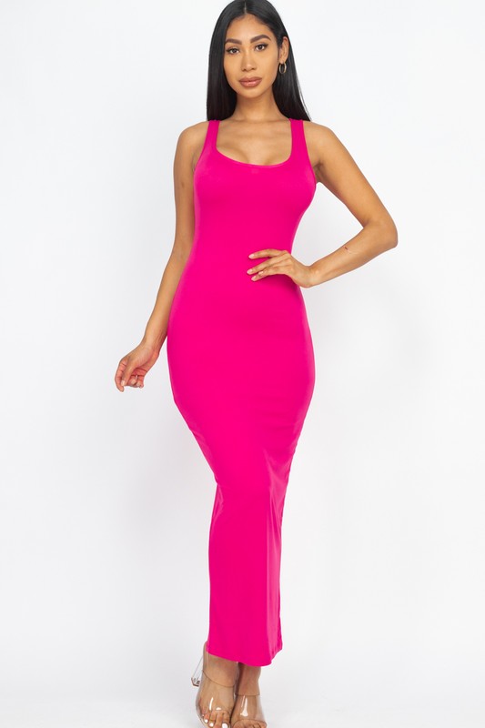 Woman wearing a bright pink sleeveless dress on a white background