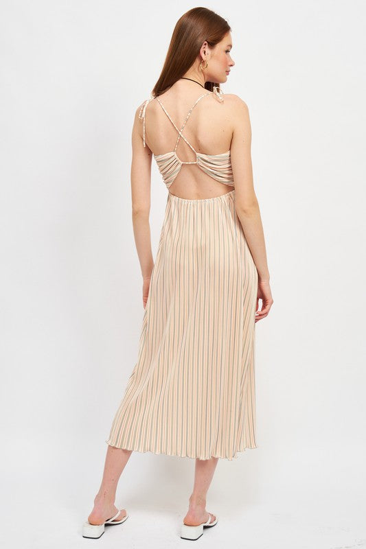 Woman wearing a beige dress with open back on a white background