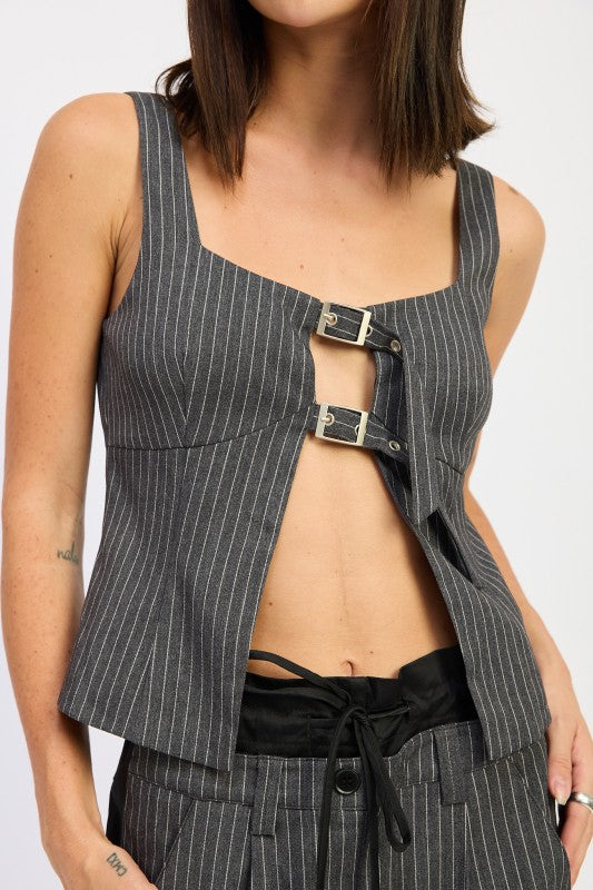 Buckle detail at the neckline adds an edgy, stylish accent.