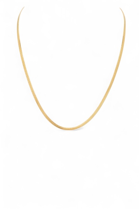 Lady wearing a sleek, minimalist gold necklace with a smooth, curved design, elegant, modern, and perfect for layering or solo statement styling.
