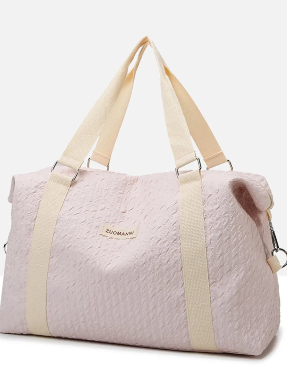 Light pink duffel bag with cream-colored handles and shoulder strap, featuring a quilted texture and a front label. Soft, stylish design—perfect for gym, travel, or casual use.