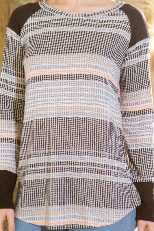 A refined knit piece that combines texture and stripe design for understated elegance.