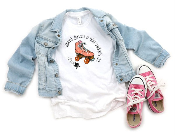 White t-shirt with roller skate graphic, light blue denim jacket, and pink sneakers on a white background