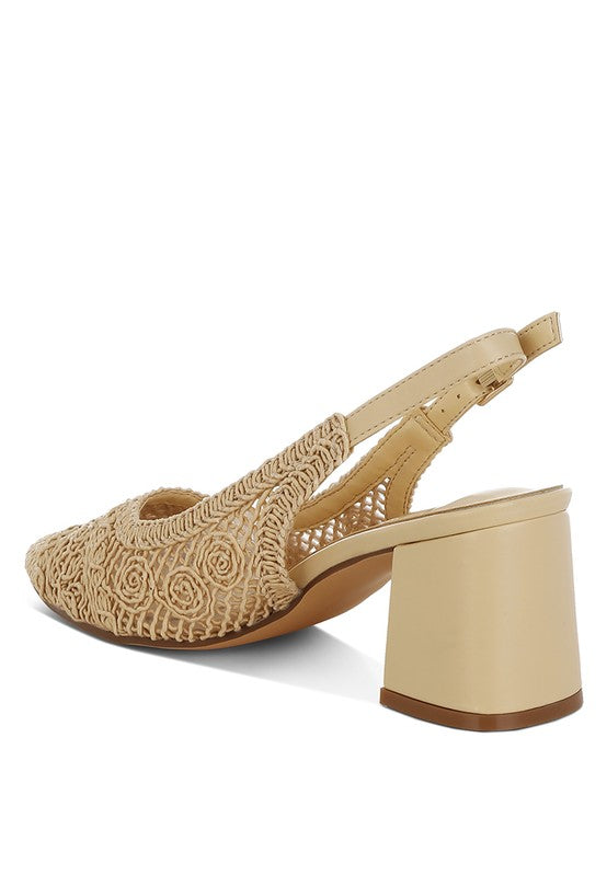 a stylish women's shoe with a closed, almond toe and an intricate lace-like upper in a light beige color.