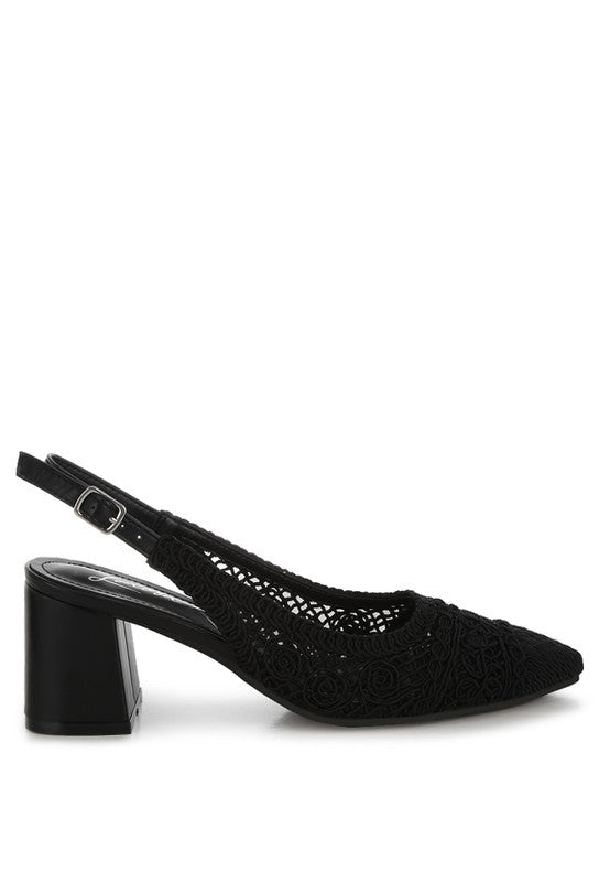 a stylish women's shoe with a closed, almond toe and an intricate lace-like upper in a light beige color.