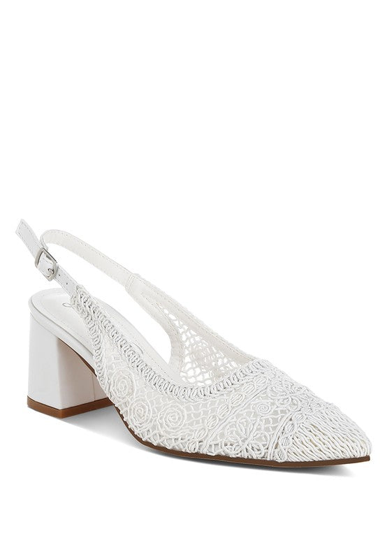 a white stylish women's shoe with a closed, almond toe and an intricate lace-like upper in a light beige color.