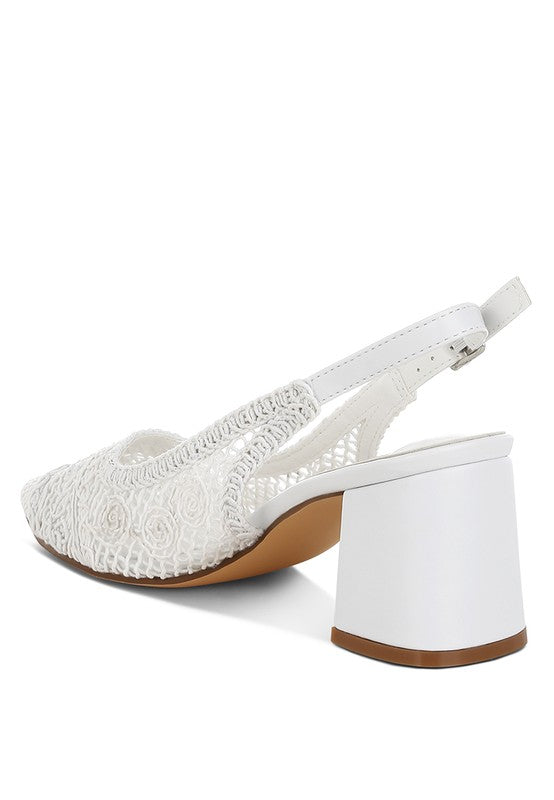 a white stylish women's shoe with a closed, almond toe and an intricate lace-like upper in a light beige color.