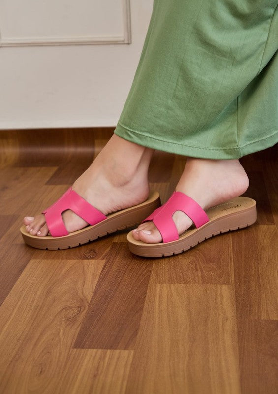 Flatform sandals featuring broad leather upper with side cutouts, open-toe silhouette, and thick textured platform sole