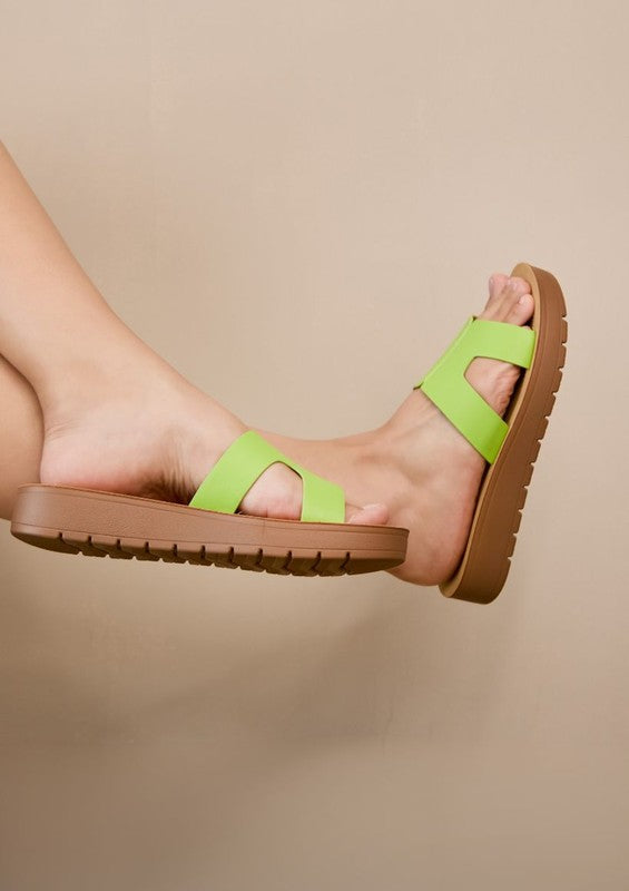 Flatform sandals featuring broad leather upper with side cutouts, open-toe silhouette, and thick textured platform sole