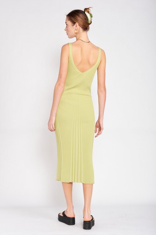 Woman wearing a light green dress with a backless design on a white background