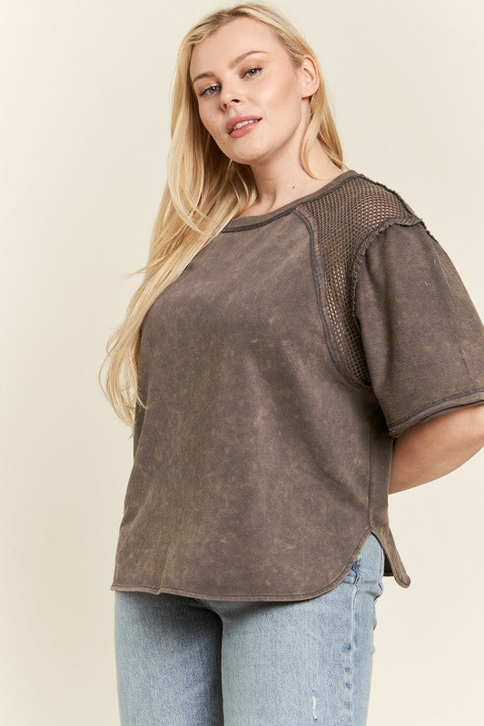 Fishnet panels on the shoulders add edgy, stylish contrast.