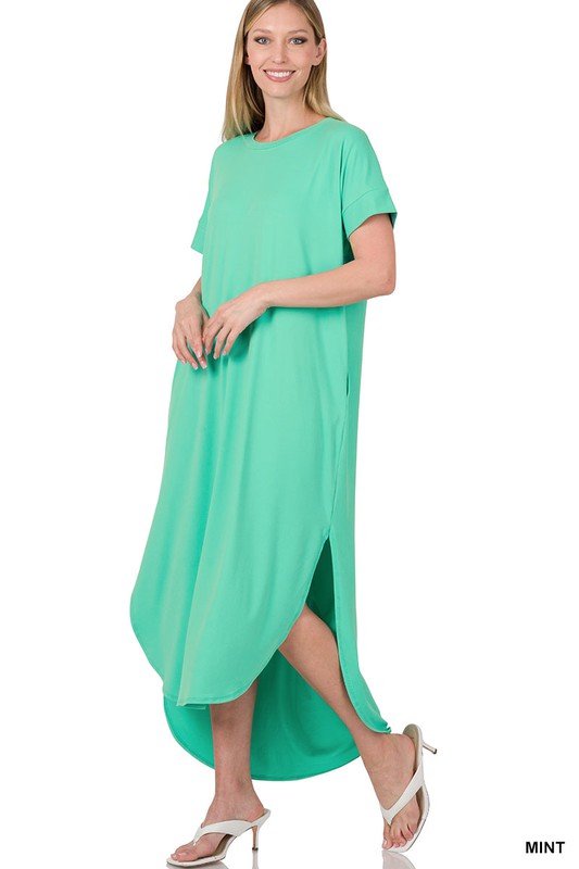 A bright coral-green dress with short sleeves and a loose, draped silhouette that falls to about knee or mid-calf length.