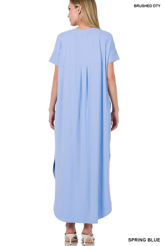 A bright coral-light blue dress with short sleeves and a loose, draped silhouette that falls to about knee or mid-calf length.