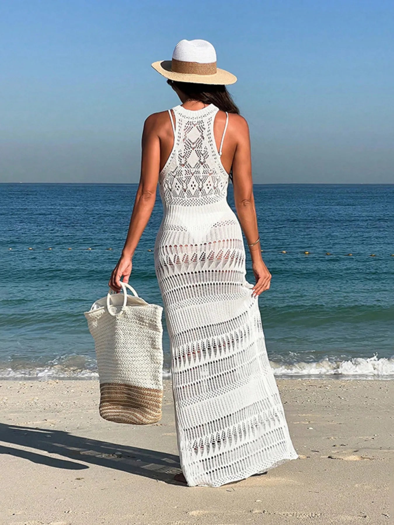 The Women’s Crochet Sleeveless Split Cover-Up Maxi Dress features a delicate crocheted bodice and flowing maxi skirt with a daring front split, offering a breezy, beach-ready silhouette with effortless layering over swimwear.
