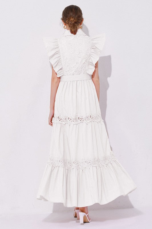 A white, midi-length piece with a tiered, ruffled silhouette and short puff sleeves, featuring delicate lace detailing for a romantic, bohemian look.