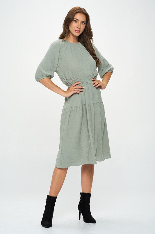 Women's textured gauze tiered midi dress with elastic waist and 3/4 puff sleeves.