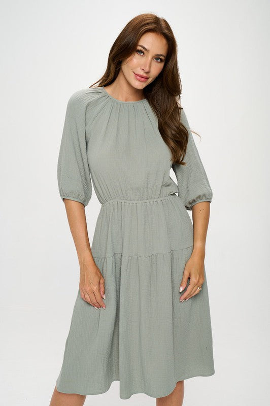 Women's textured gauze tiered midi dress with elastic waist and 3/4 puff sleeves.